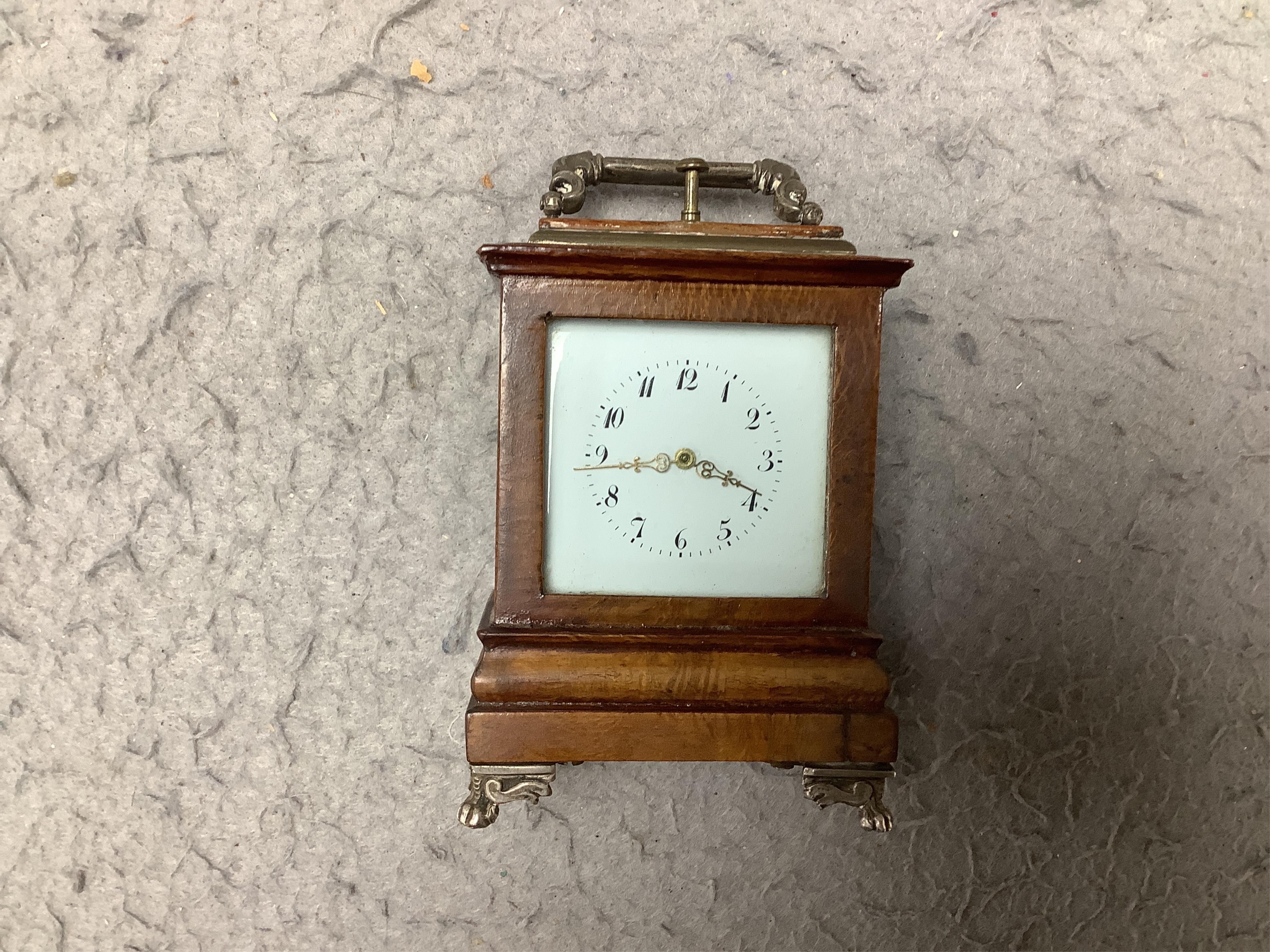 An early 20th century walnut miniature repeating carriage clock, with key, 8.5cm. Condition - fair, currently ticking